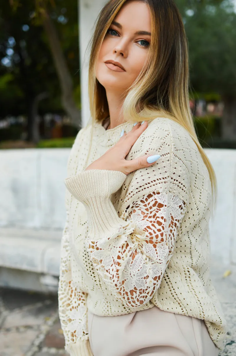 Model wearing elegant hand-knitted sweater